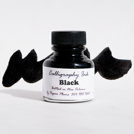 Black calligraphy ink in a glass bottle by Papier Plume, featuring elegant ink for artistic lettering and writing.