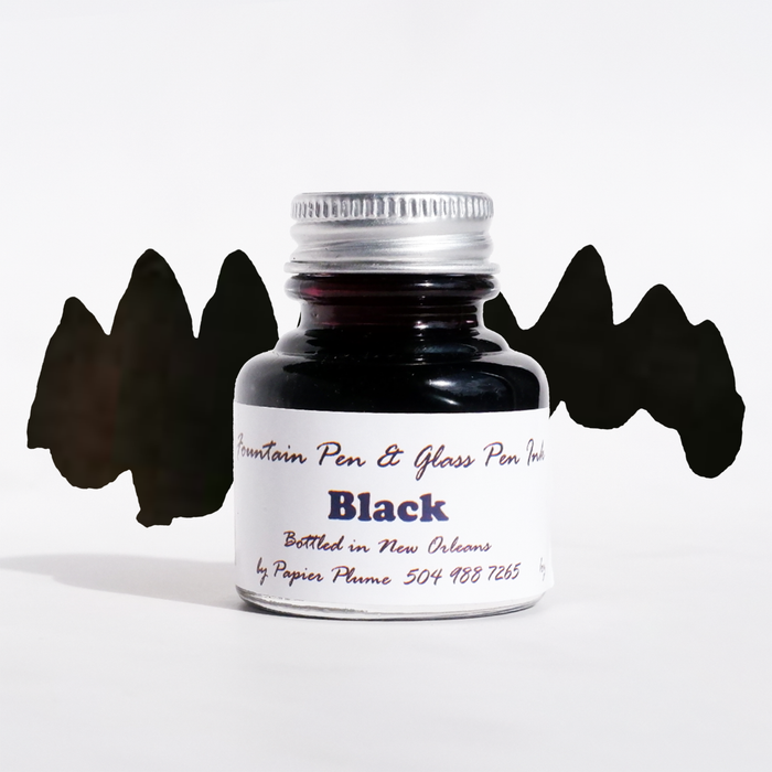 Papier Plume black fountain pen ink bottle with black ink inside, ideal for writing with fountain pens.
