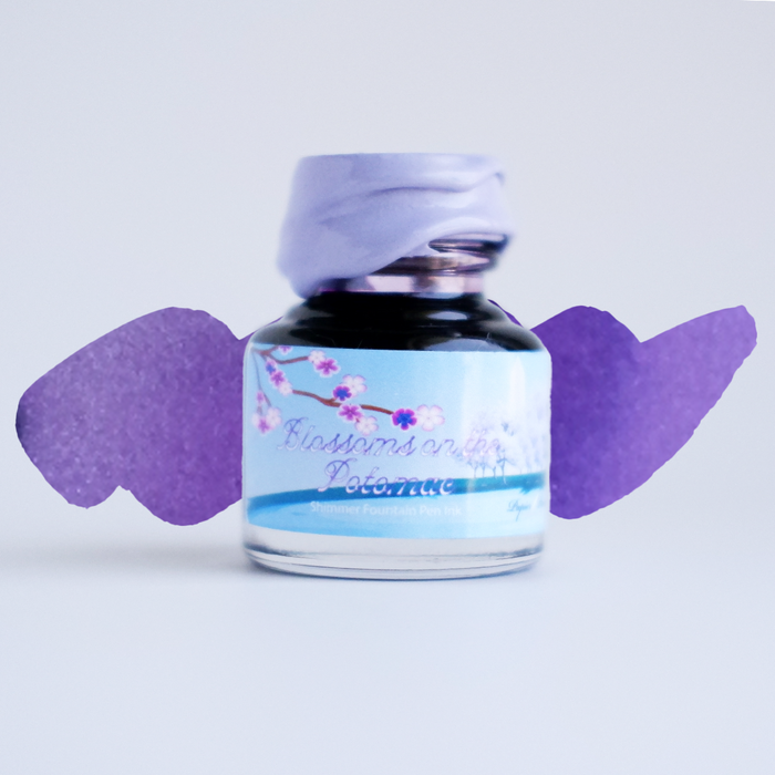 Papier Plume DC Pen Show Blossoms on the Potomac fountain pen shimmer ink in a glass bottle with floral design label.