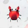 Colorful paper beach crab craft by Assembli, featuring vibrant paper claws and detailed design for creative beach-themed decorations.