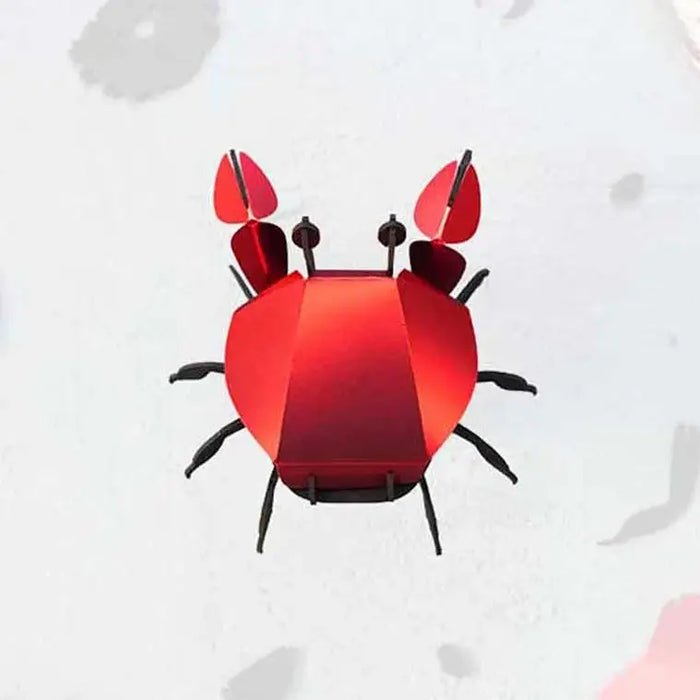 Colorful paper beach crab craft by Assembli, featuring vibrant paper claws and detailed design for creative beach-themed decorations.