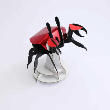 Colorful paper beach crab craft by Assembli, featuring detailed crab shape made from vibrant paper materials.