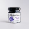 Anderillium Betta Fish Purple fountain pen ink in a bottle with a colorful label, showcasing vibrant purple ink for writing.