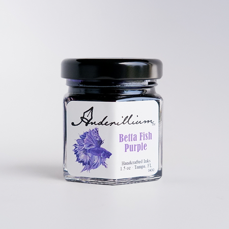Anderillium Betta Fish Purple fountain pen ink in a bottle with a colorful label, showcasing vibrant purple ink for writing.