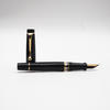 Aurora Optima black fountain pen with gold trim, featuring a sleek design and smooth ink flow.