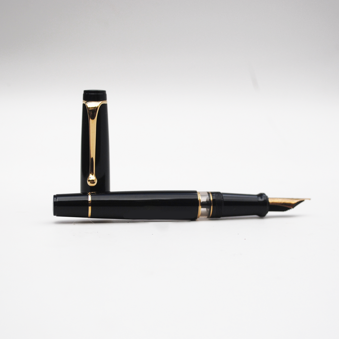 Aurora Optima black fountain pen with gold trim, featuring a sleek design and smooth ink flow.