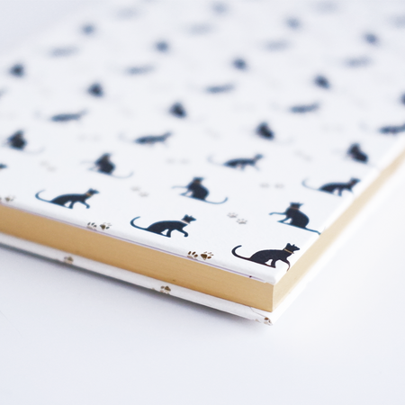 Black Rossi cat journal with a sleek cover, featuring feline artwork and lined pages for notes and journaling.