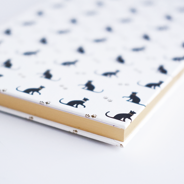 Black Rossi cat journal with a sleek cover, featuring feline artwork and lined pages for notes and journaling.
