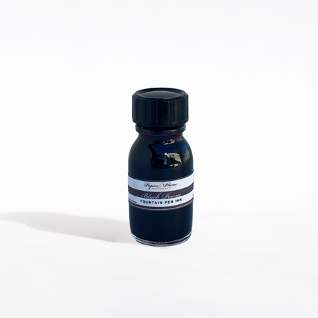 Bottle of Papier Plume fountain pen ink in Black Peony color, with black ink swatch on white background.