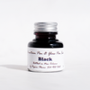 Black fountain pen ink bottle by Papier Plume, showcasing smooth ink for elegant writing and calligraphy.