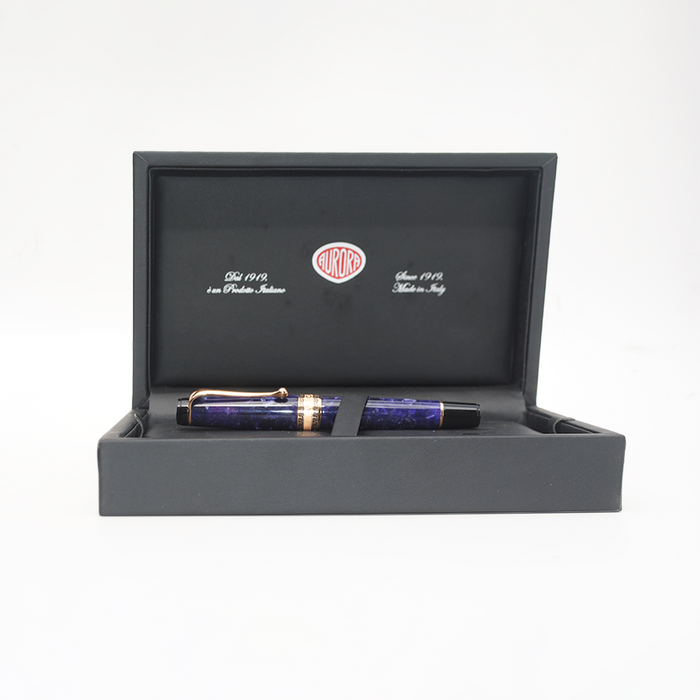 Aurora Optima violet fountain pen with rose gold trim, featuring a sleek blue body and elegant design.
