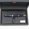 Aurora Optima Violet Auroraloide fountain pen with rose gold trim, featuring a sleek blue body and elegant design.