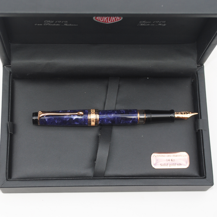Aurora Optima Violet Auroraloide fountain pen with rose gold trim, featuring a sleek blue body and elegant design.