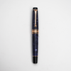 Aurora Optima Violet Auroraloide fountain pen with rose gold trim, blue body, and elegant design.