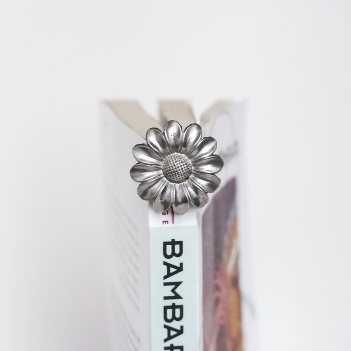 Le Potier D'Etain fishhook bookmark with a delicate flower design, ideal for marking pages in books with elegant style.