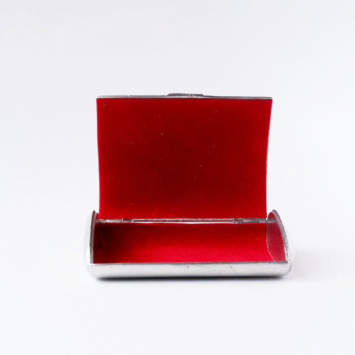 Le Potier D'etain card holder featuring a sleek, metallic design with engraved details, compact and stylish for everyday use.