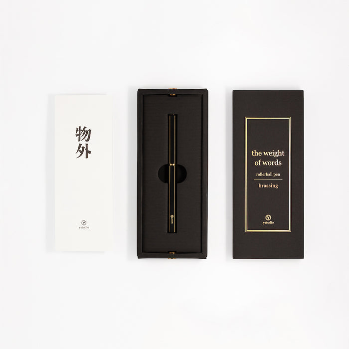 Y Studio Classic Revolve black rollerball pen with metallic finish, displayed in its packaging.