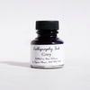 Papier Plume bottled calligraphy ink in grey with a glass bottle and black cap, ideal for artistic lettering and writing projects.
