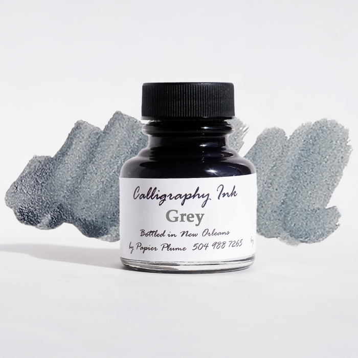 Gray calligraphy ink in a Papier Plume bottled container, ideal for elegant handwriting and artistic lettering projects.