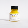 Yellow bottled calligraphy ink from Papier Plume, showcasing smooth, vibrant ink ideal for elegant calligraphy writing.