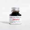 Papier Plume fountain pen ink in caramel color, showing a bottle with smooth caramel-colored ink inside.