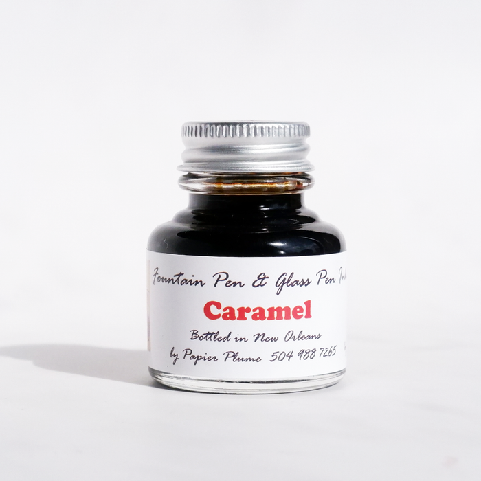Papier Plume fountain pen ink in caramel color, showing a bottle with smooth caramel-colored ink inside.
