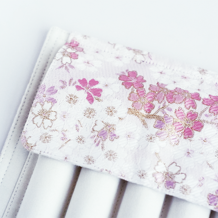 Cathay Snowlit Bloom pen case featuring a floral design with soft pastel colors and a sleek, compact shape for storing writing instruments.