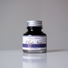 Black fountain pen ink bottle from Papier Plume's Chat Noir collection, featuring elegant ink in a glass container