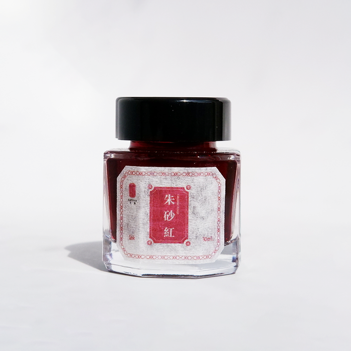 Bottle of Cathay Cinnabar Rouge fountain pen ink with vibrant red ink visible in the glass container.