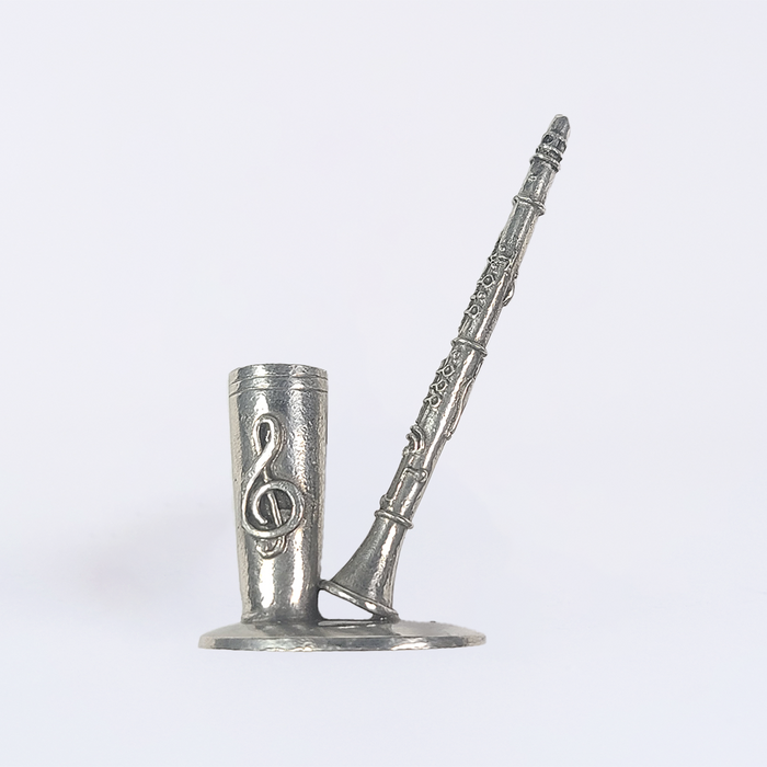 Pewter clarinet-shaped pen rest by Le Potier D'Étain, designed to hold a quill or writing instrument securely.