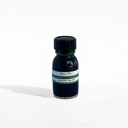 Bottle of Papier Plume Colibri fountain pen ink with vibrant blue ink visible inside the glass bottle.
