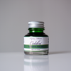 Papier Plume Colibri fountain pen ink bottle with vibrant ink inside, designed for smooth writing and elegant calligraphy.
