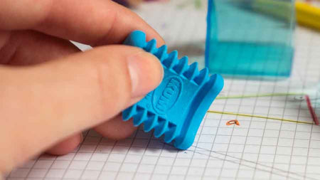 KUM Softi Tri Pop triangle eraser in pastel colors, designed for precise and comfortable pencil erasing on paper.