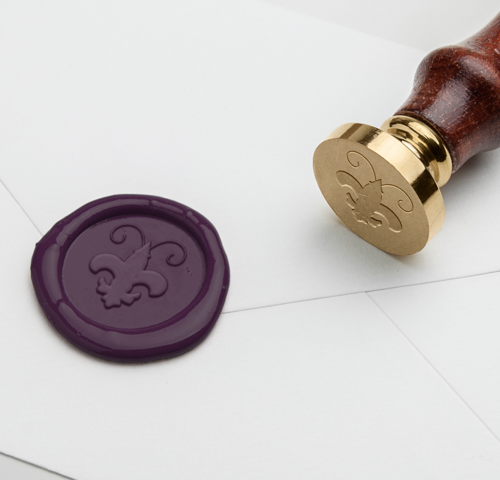 Papier Plume wax seal featuring a crawfish and Fleur de Lis symbol on a natural-colored wax stamp.
