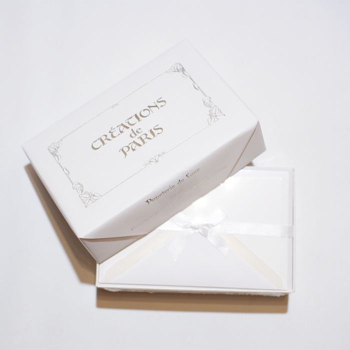 Rossi flat deckled edge cards and lined envelopes in white, showcasing elegant stationery design and textured paper.
