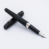 Matte black Diplomat Cobra fountain pen with sleek design and gold accents, shown resting on a white surface.