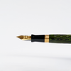 Wahl-Eversharp Decoband green ebonite chased fountain pen with gold trim, showcasing elegant design and craftsmanship.