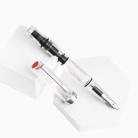 Twsbi Eco-T Clear fountain pen with transparent body and silver accents, showcasing the pen's internal components and sleek design.