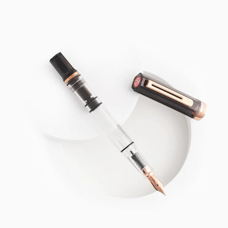 Twsbi Eco fountain pen in smoke Rose Gold with a sleek body and silver accents, displayed on a white background.