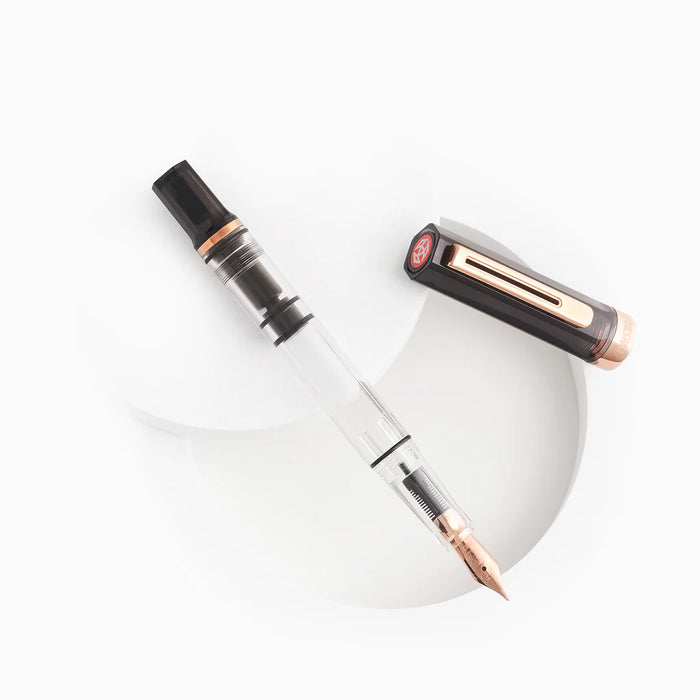 Twsbi Eco fountain pen in smoke Rose Gold with a sleek body and silver accents, displayed on a white background.