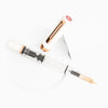 Twsbi Eco fountain pen with white body and rose gold accents, sleek and elegant writing instrument on a neutral background.