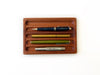 Eng Leather Co. wooden pen tray with compartments for organizing pens and stationery in a sleek, natural wood finish.