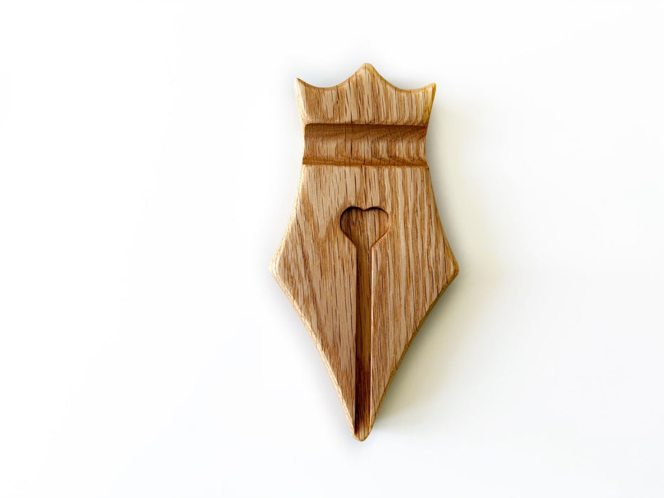 Eng Leather Co. wooden pen rest with a sleek design, featuring a slot for holding a pen on smooth oak wood surface.