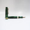 Gioia Metis 2.0 fountain pen in emerald green with gold accents, showcasing its sleek design and fine nib.