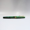 Gioia Metis 2.0 fountain pen in emerald green with gold accents, showcasing its sleek design and glossy finish.