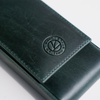 Green leather pen case from Eng Leather Co. with three compartments for storing pens and writing instruments.