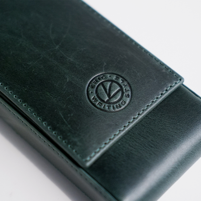 Green leather pen case from Eng Leather Co. with three compartments for storing pens and writing instruments.