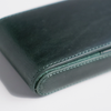 Green leather pen case by Eng Leather Co. with three slots for pens, compact and stylish storage solution.