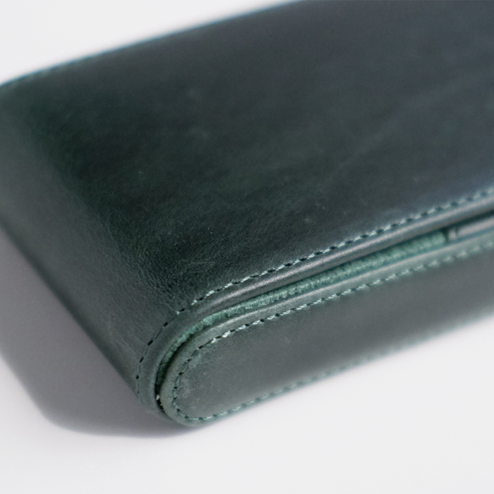 Green leather pen case by Eng Leather Co. with three slots for pens, compact and stylish storage solution.