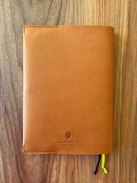 A vegan leather A5 journal cover by Eng Leather Co. in camel color, designed to protect and stylishly hold a notebook.
